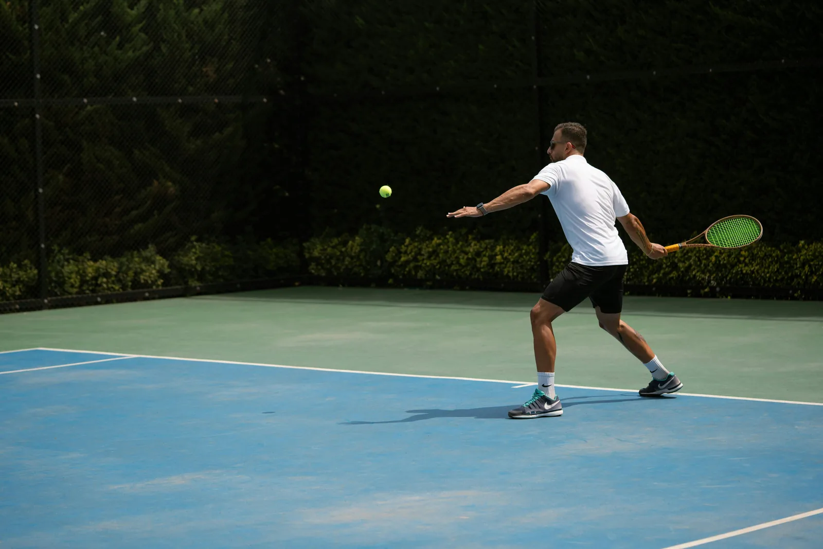 Tennis player hitting a forehand on an outdoor court